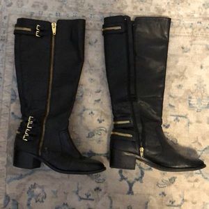 Black boots with gold zipper embellishments
